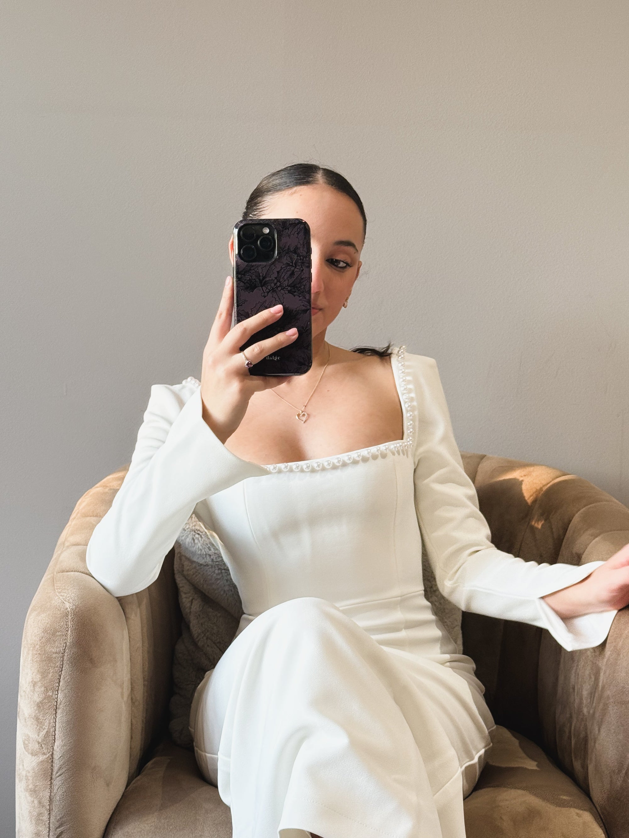  "A girl holding an iPhone with a stylish Dalge phone case, smiling as she takes a selfie using creative photography settings."