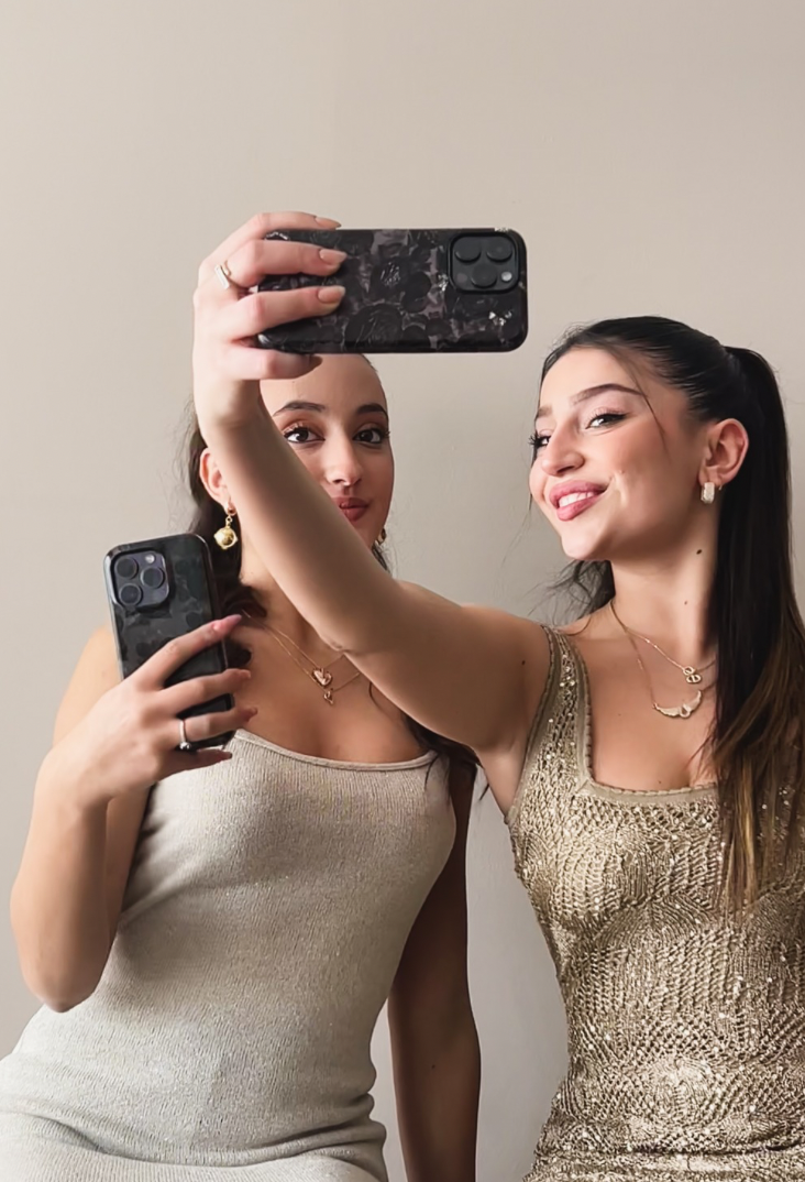 Image featuring girls holding designed iPhone 16 cases adorned with floral patterns,  highlighting their stylish and modern appeal.